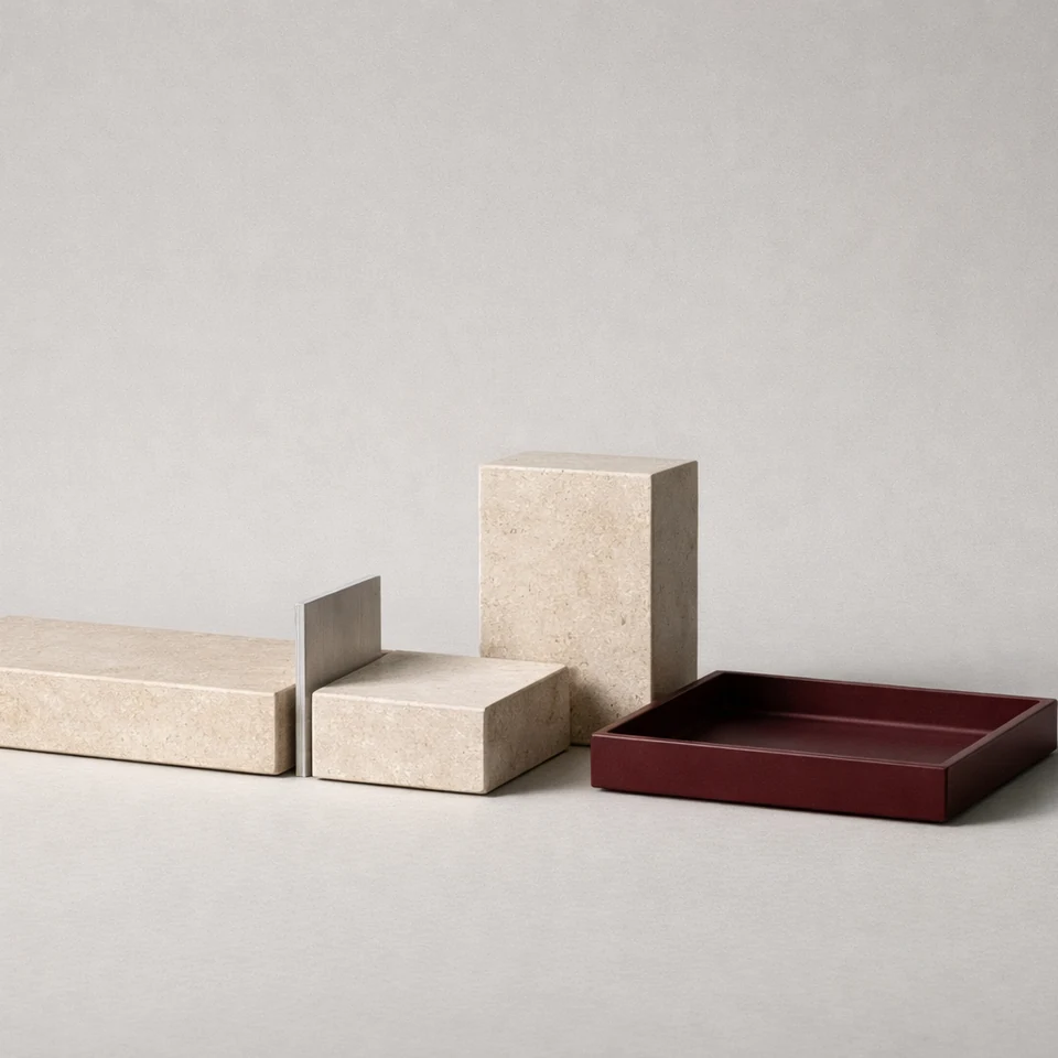 Pale stone blocks and a divider beside a burgundy tray